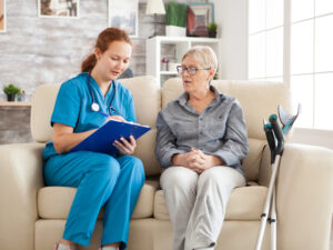 Female doctor in nursing home doing survey on senior woman