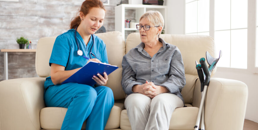 Female doctor in nursing home doing survey on senior woman